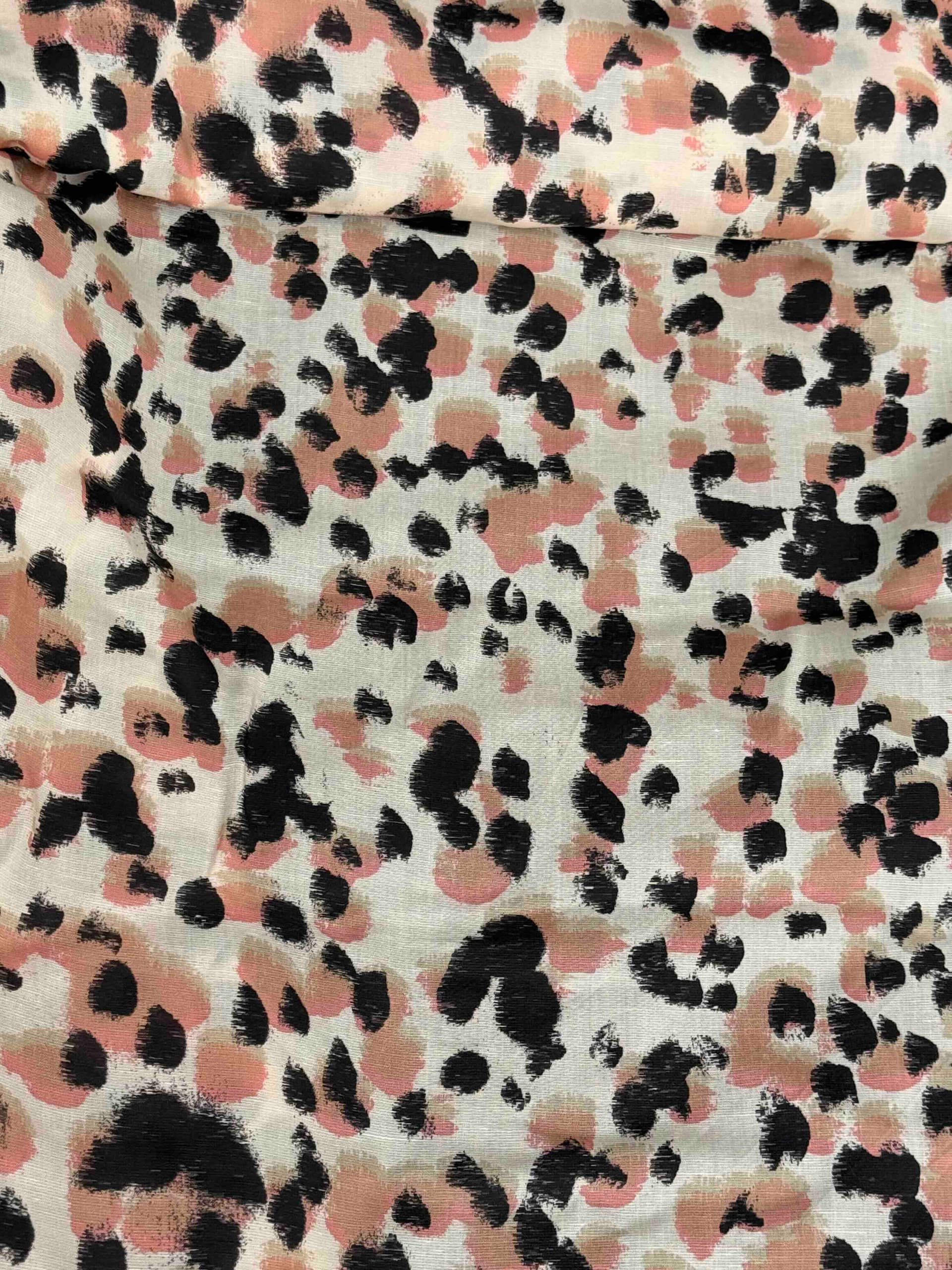 Linen Tencel blend, fabric with an animal style print - black, brown and pink spots on a cream background